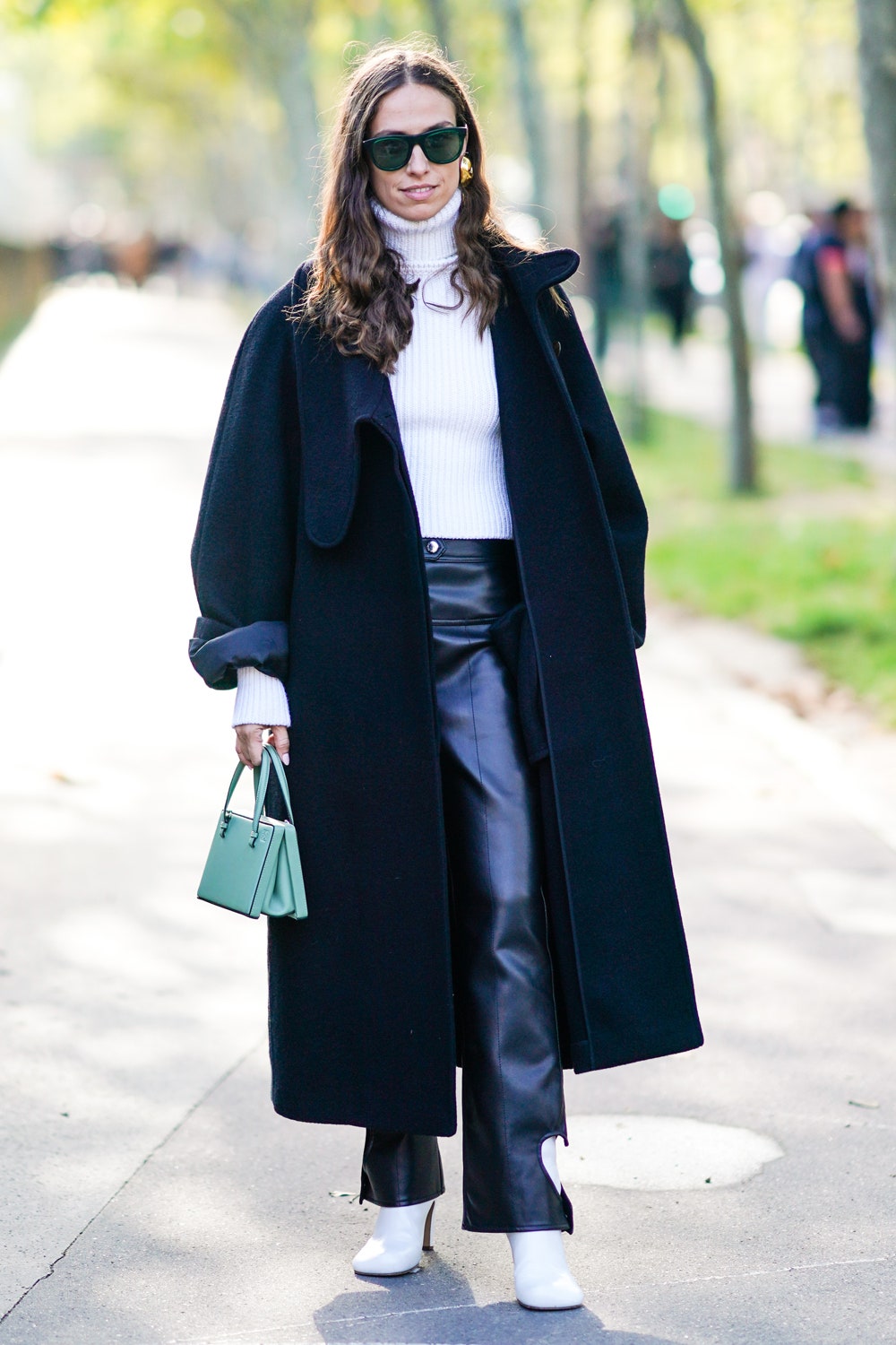 PARIS FRANCE  SEPTEMBER 27 Erika Boldrin wears sunglasses a white wool turtleneck pullover a black oversized coat a...