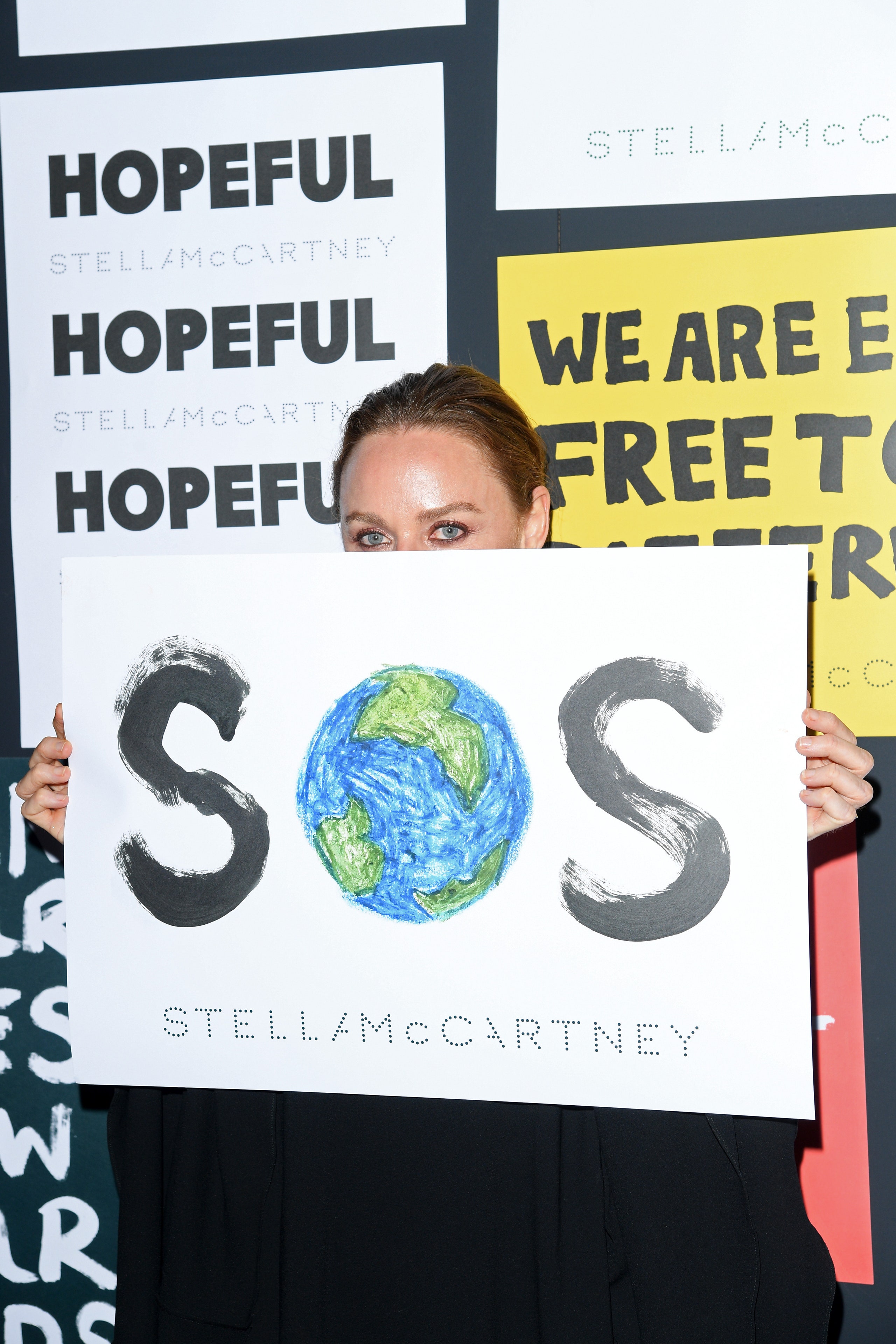 MILAN ITALY  JUNE 14 Stella McCartney poses with a sign readin 'SOS' during the presentation of Stella McCartney during...