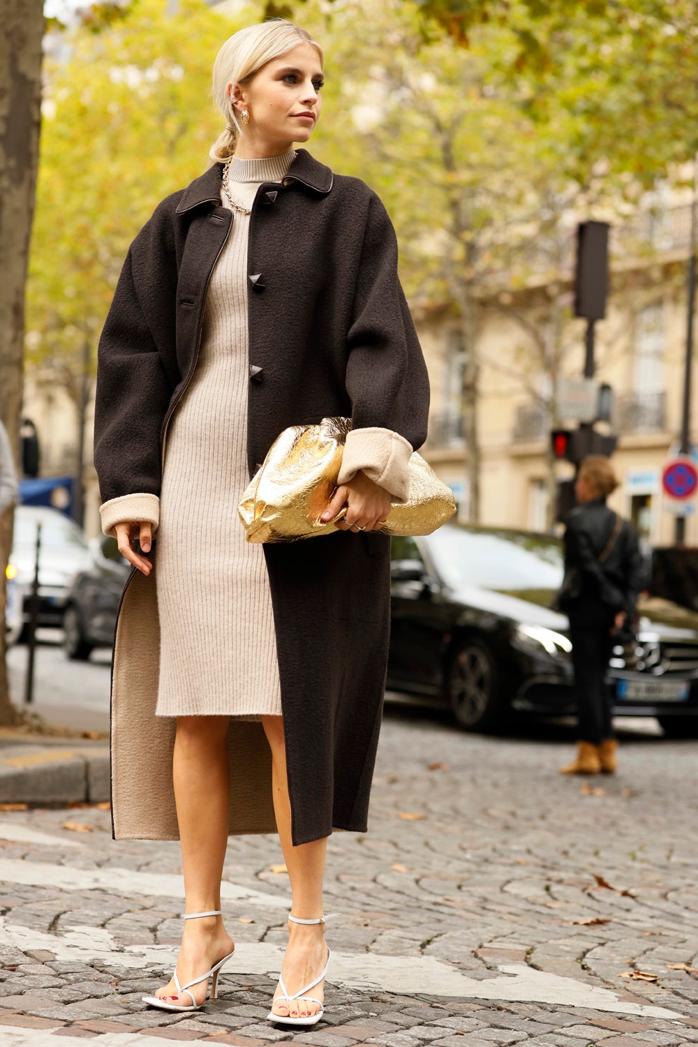 PARIS FRANCE  SEPTEMBER 28 Caroline Daur wearing beige knit dress and dark brown coat outside the Altuzarra show during...