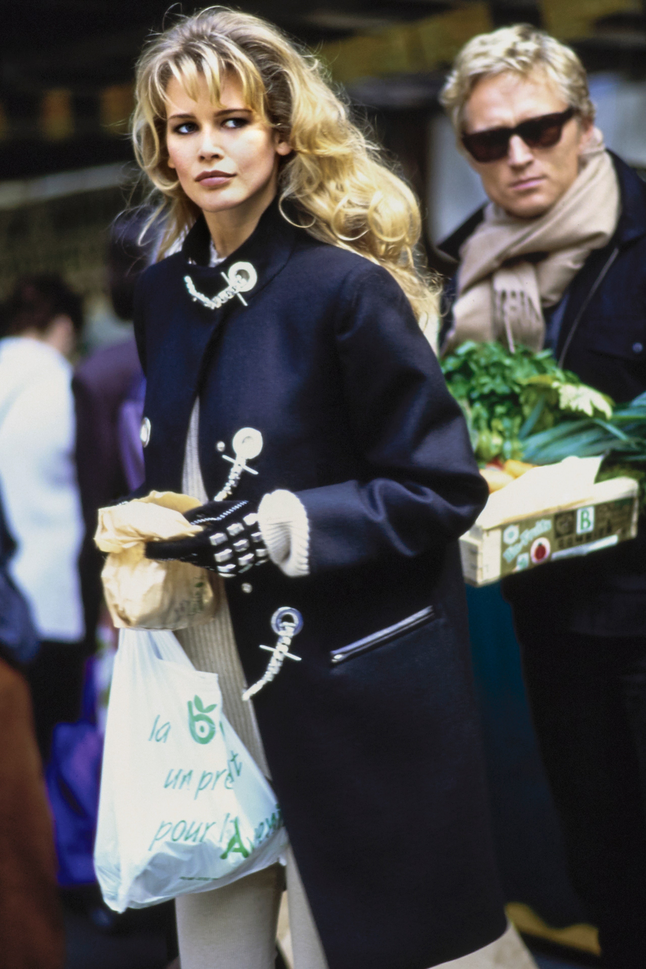 Vogue September 1992  Model Claudia Schiffer walking down the street with shopping bags in her hands an unidentified...