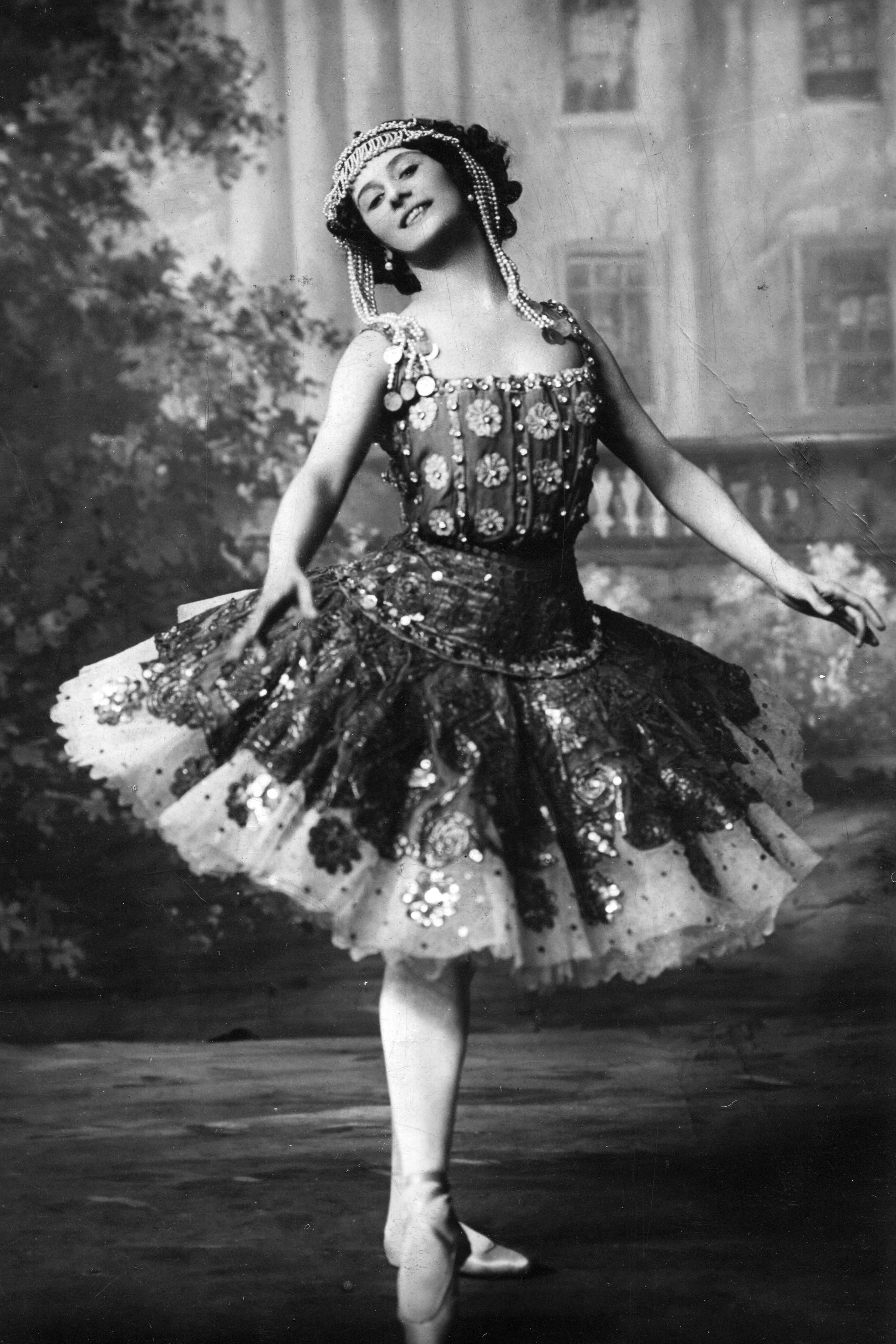 In full costume a happy Anna Pavlova strikes a pose for a photo postcard produced in Paris France around 1910.