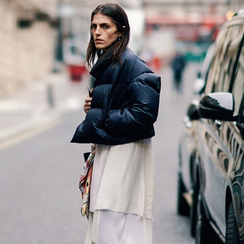 LONDON ENGLAND  FEBRUARY 16 A guest wears a black puffer jacket a white rippedhem maxiskirt black heeled pointy pumps...