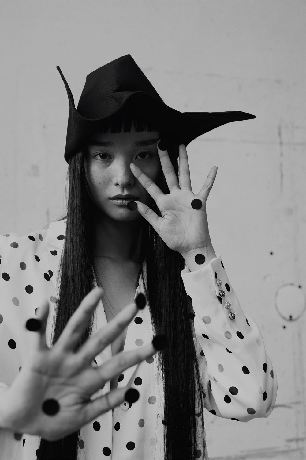 Model wearing silk polka dot blazer and cotton fabric hat