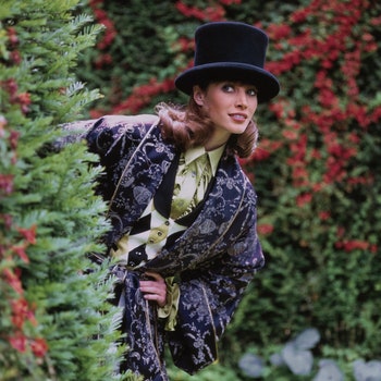 Vogue September 1992  Model Christy Turlington peering around a hedge in a large garden in Wales United Kingdom. She is...