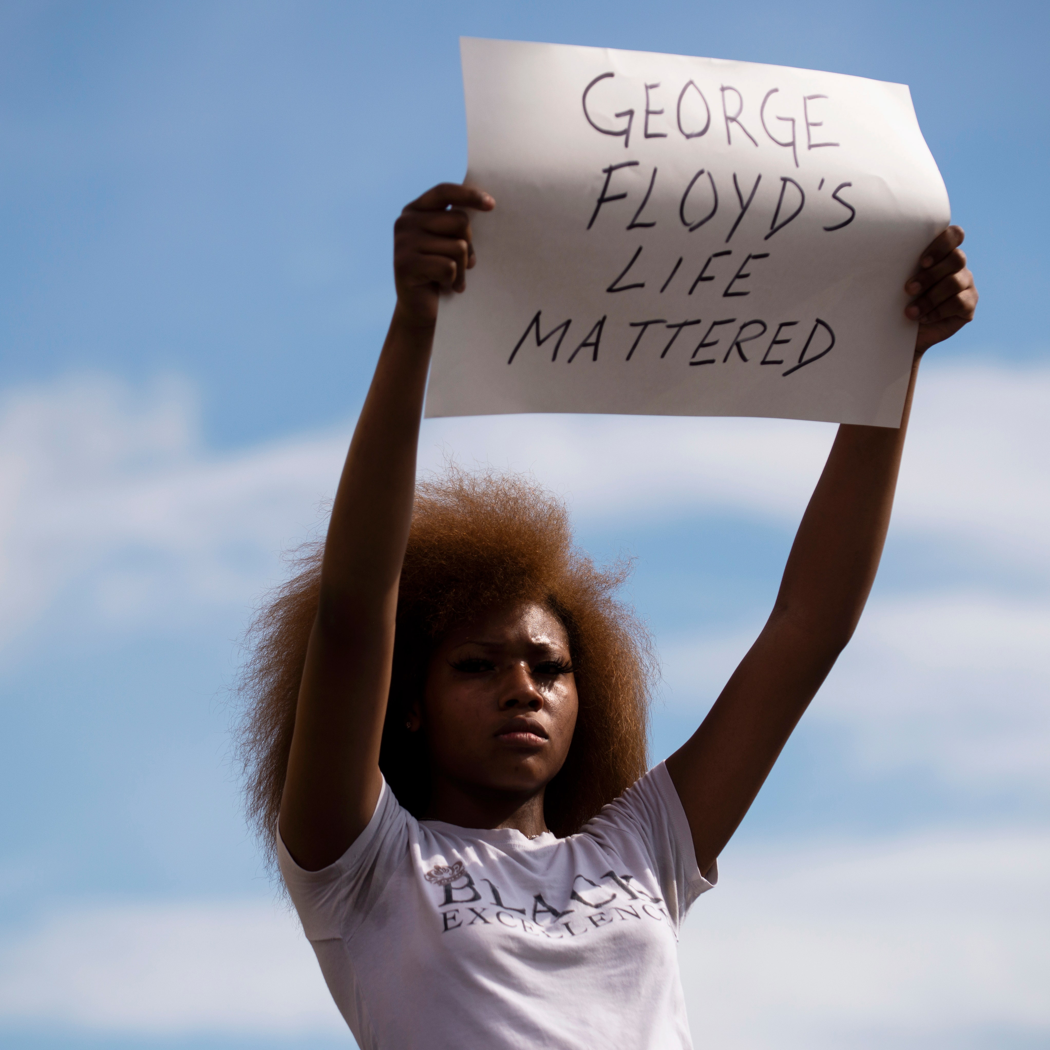 MINNEAPOLIS MN  MAY 26 A woman holds a sign stating George Floyd's Life Mattered during a protest outside the Cup Foods...