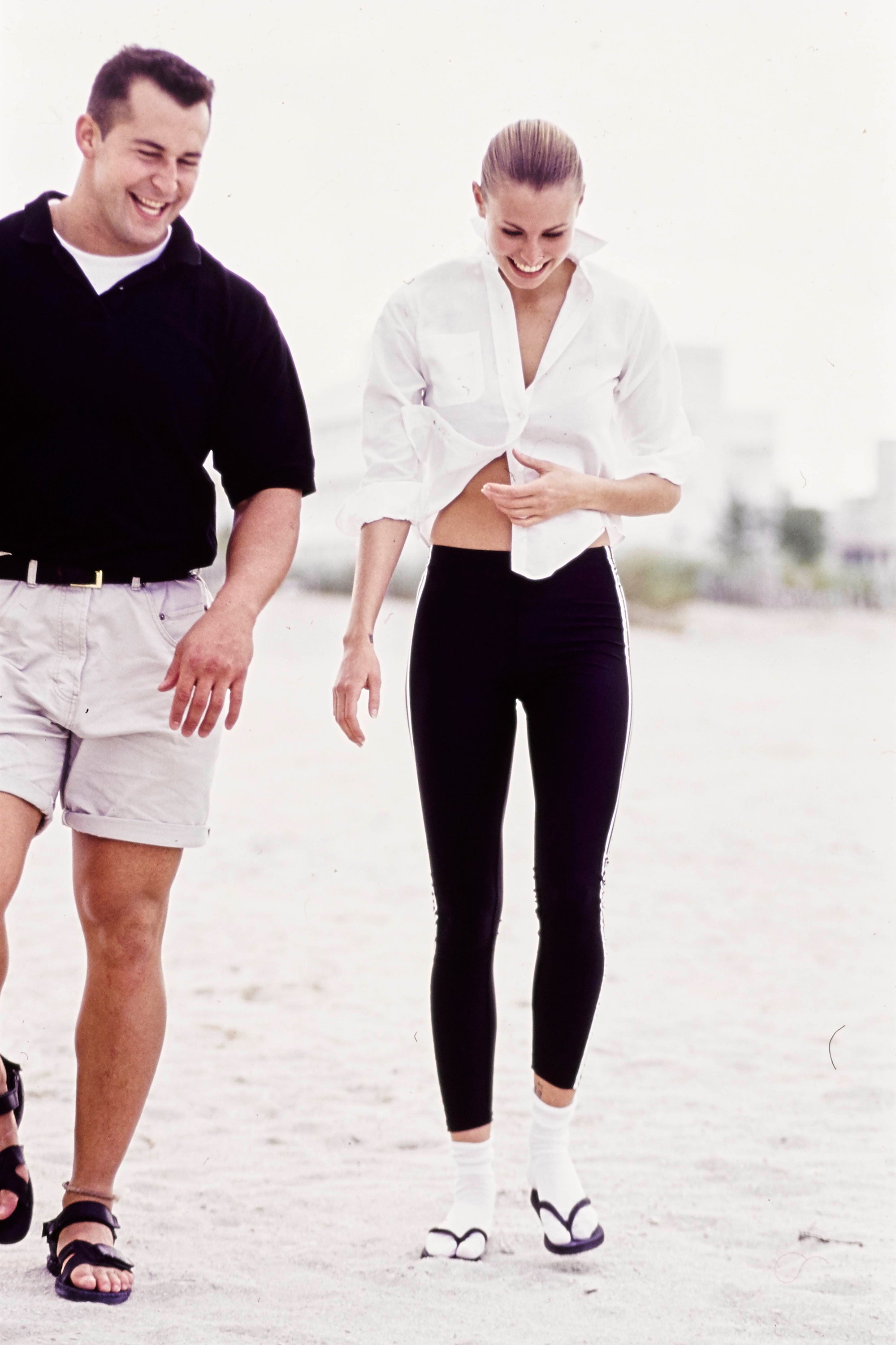 UNSPECIFIED  JANUARY 1  Model Niki Taylor walks on a beach with an unknown male wearing Adidas stretch leggings with a...