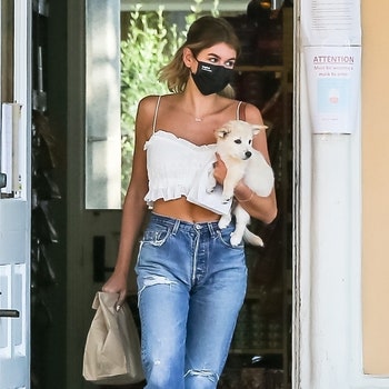 Malibu CA   EXCLUSIVE Model Kaia Gerber wears a white crop top witjj a black mask and blue jeans as she stops by a pet...