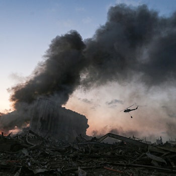 TOPSHOT  EDITORS NOTE Graphic content  A helicopter puts out a fire at the scene of an explosion at the port of...
