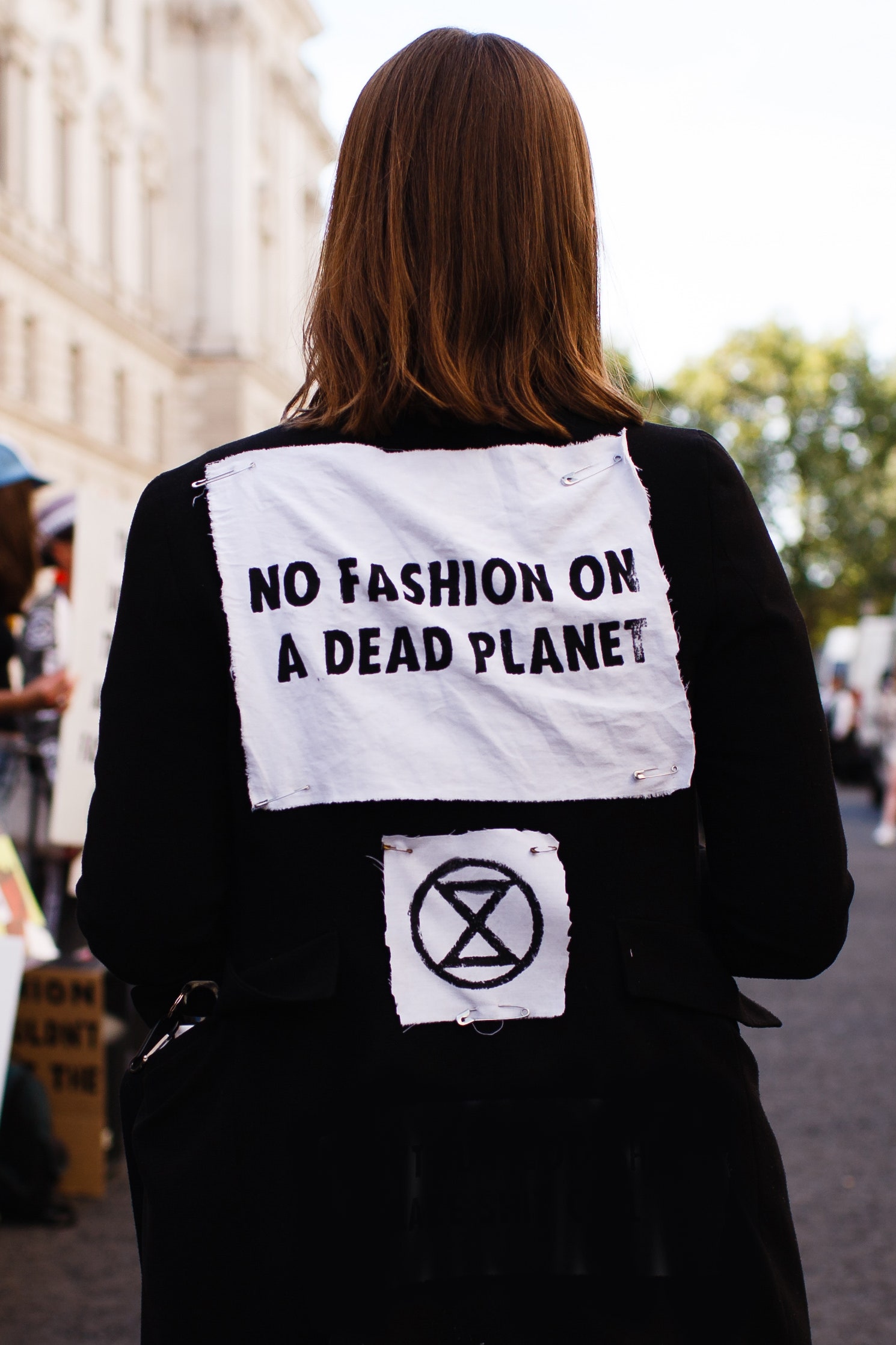 Image may contain Human Person Text Clothing Apparel Banner and Crowd