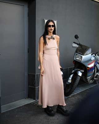 Image may contain Clothing Apparel Transportation Vehicle Motorcycle Evening Dress Fashion Gown Robe and Human