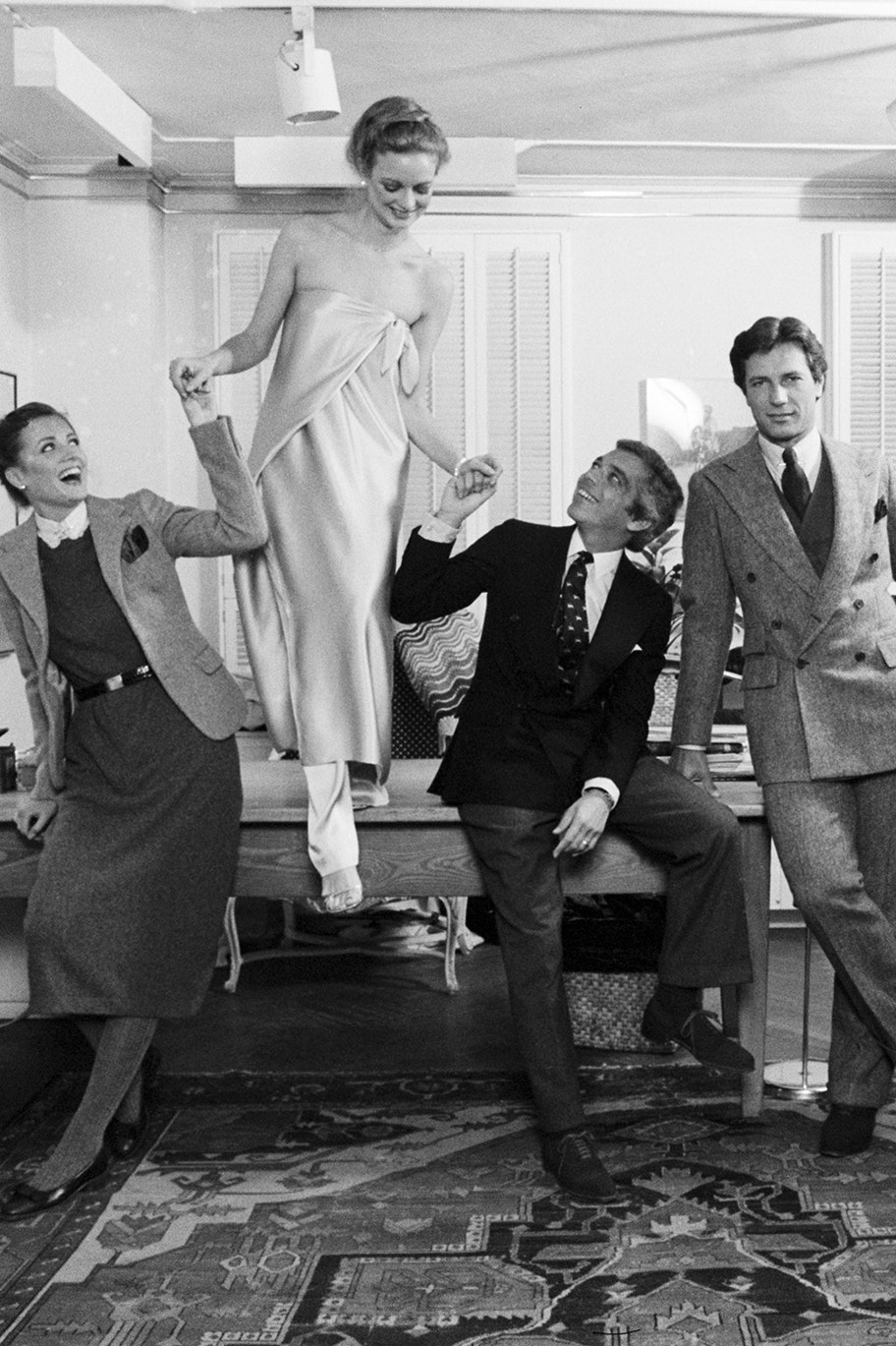Portrait of American fashion designer Ralph Lauren  along with unidentified staff members and models in his 7th Avenue...