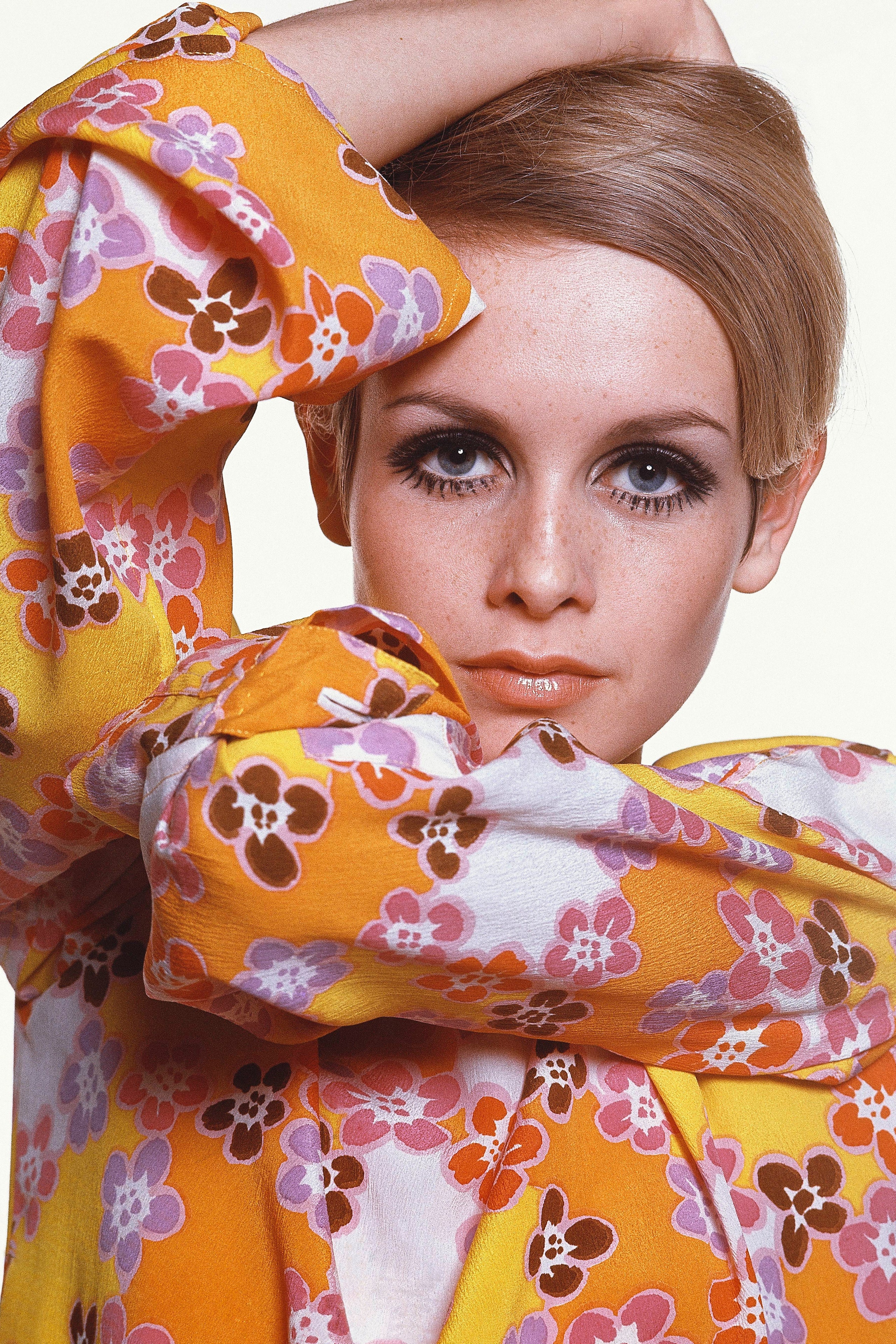 Twiggy in Max Factor makeup wearing flowered crepe dress by Michele Rosier.