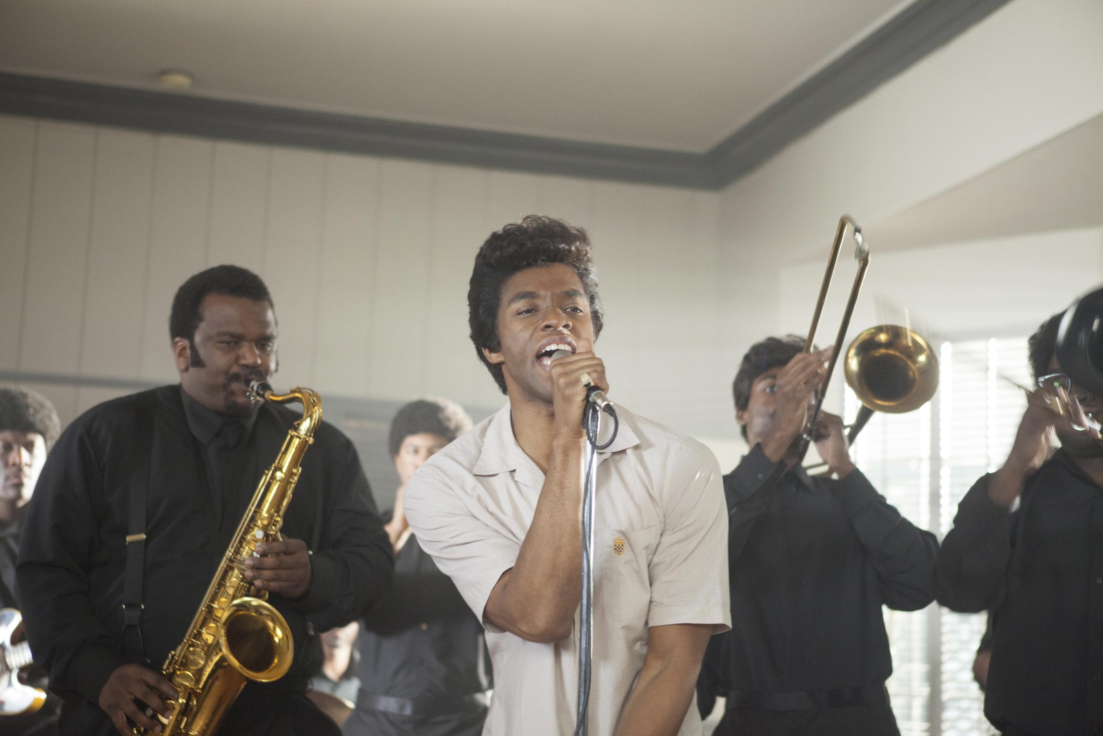 Image may contain James Brown Chadwick Boseman Human Person Musical Instrument Brass Section Horn Leisure Activities and...