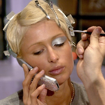 M.A.C. makeup artists apply makeup to Paris Hilton in The Jeremy Scott Fashion Show sponsored by Gillette Passion Venus...