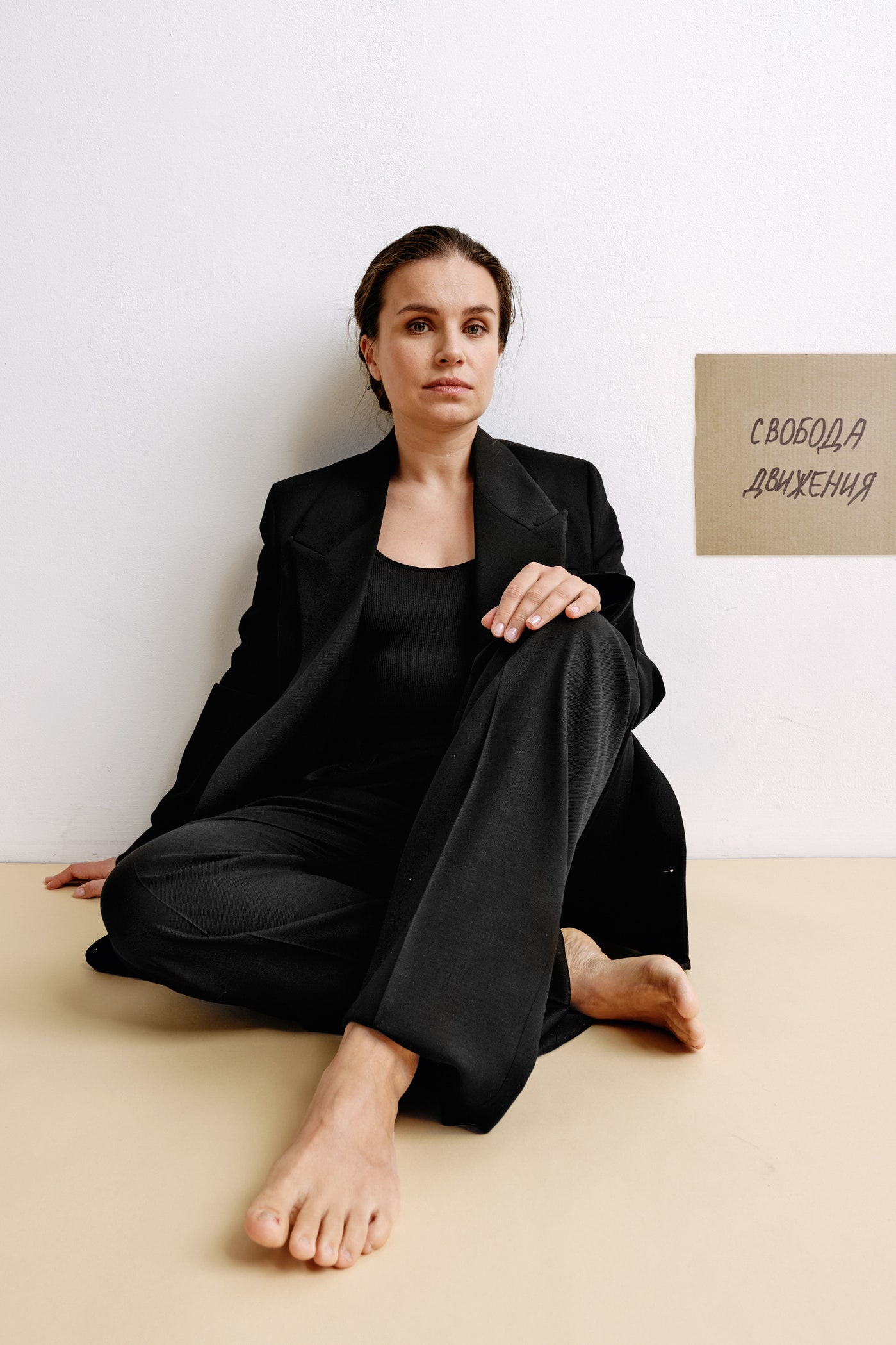 Businesswoman Olga Barabanova wearing black viscose fabric suit jacket and cotton fabric bodysuit posing in studio