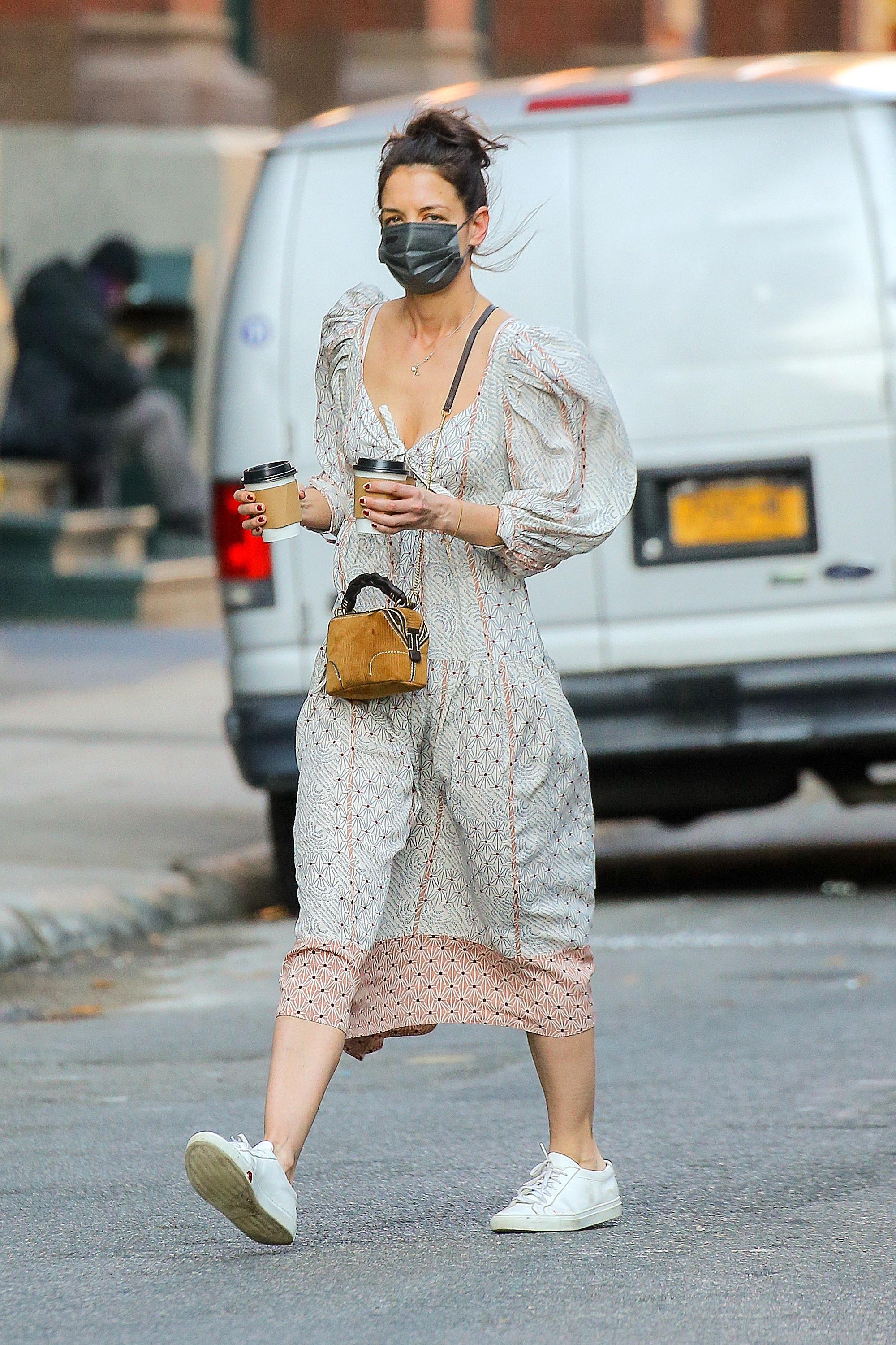 Katie Holmes steps out wearing a casual dress with pair a white sneakers while picking up coffee for two in New York...