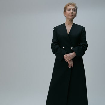 Maryana Lysenko wearing black long woollen coat and black leather boots