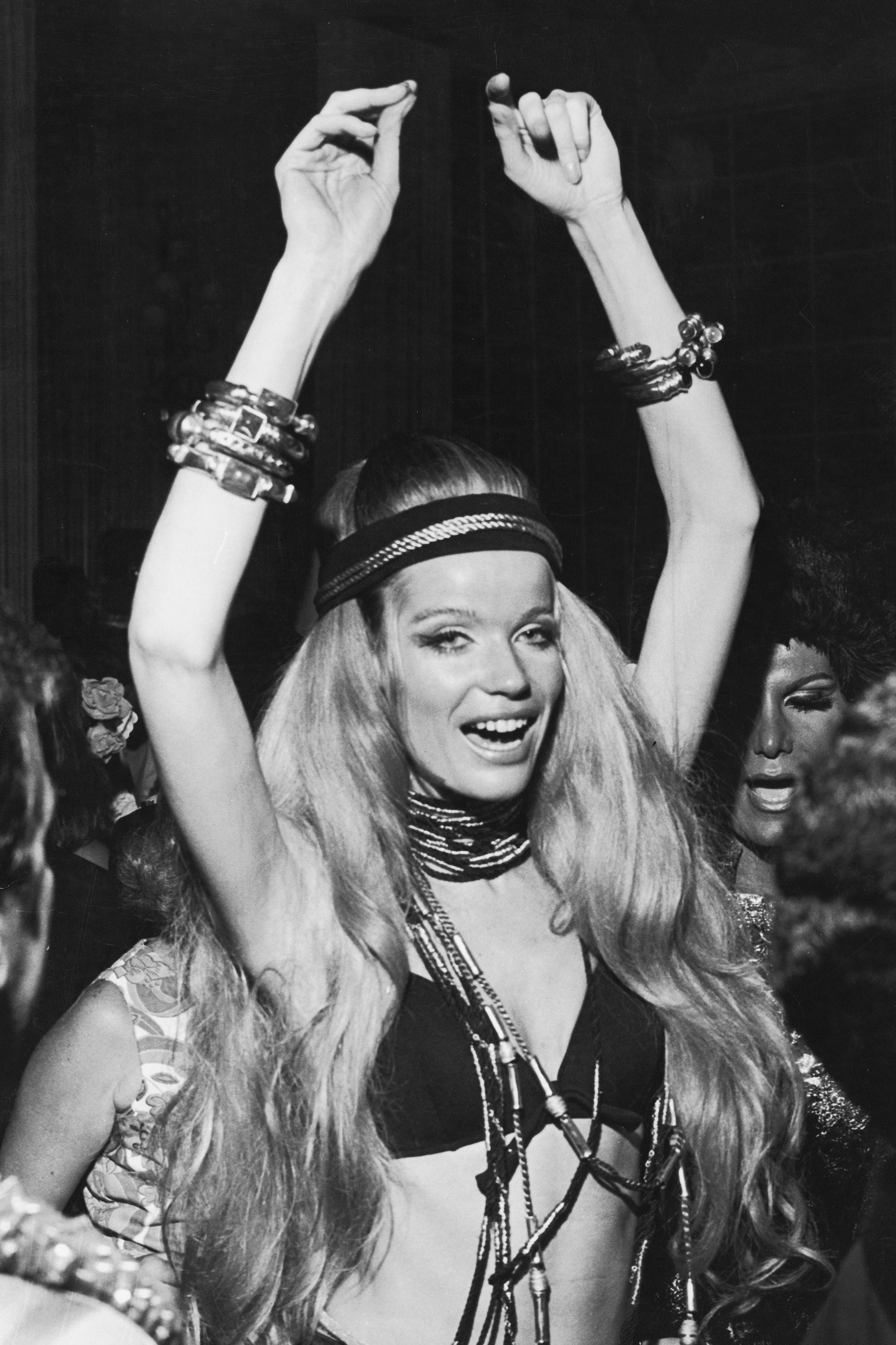German countess and fashion model Veruschka raises her arms above her head as she dances at a party during Carnaval Rio...