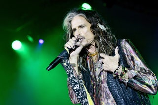 This image may contain Electrical Device Microphone Human Person Steven Tyler Musical Instrument Musician and Lighting