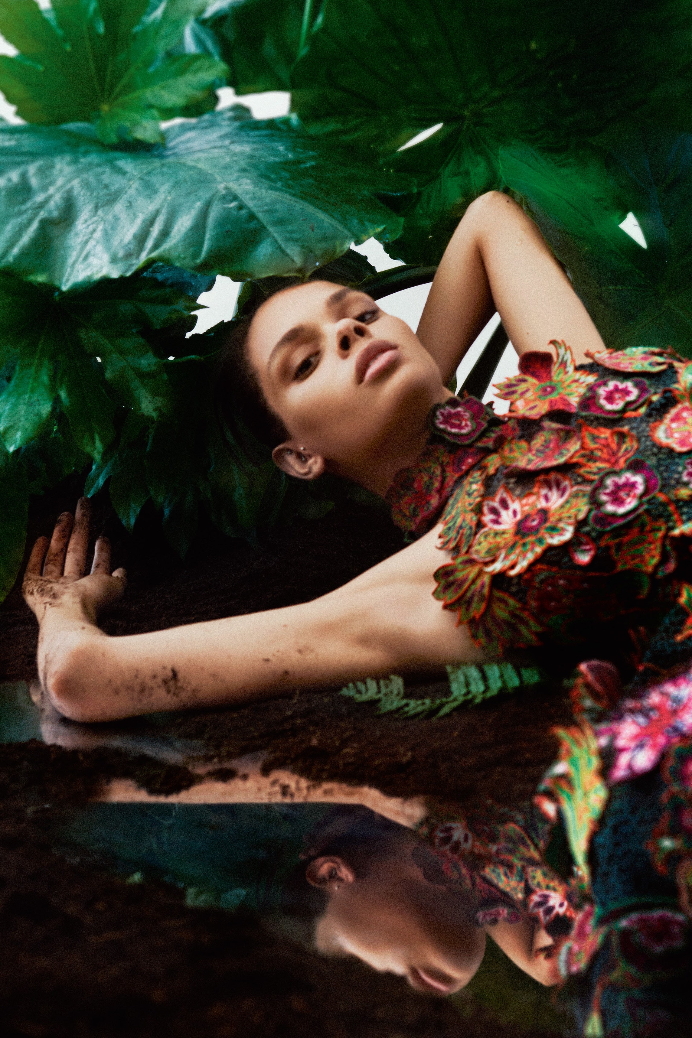 Model wearing floral pattern dress with flowers and leaves