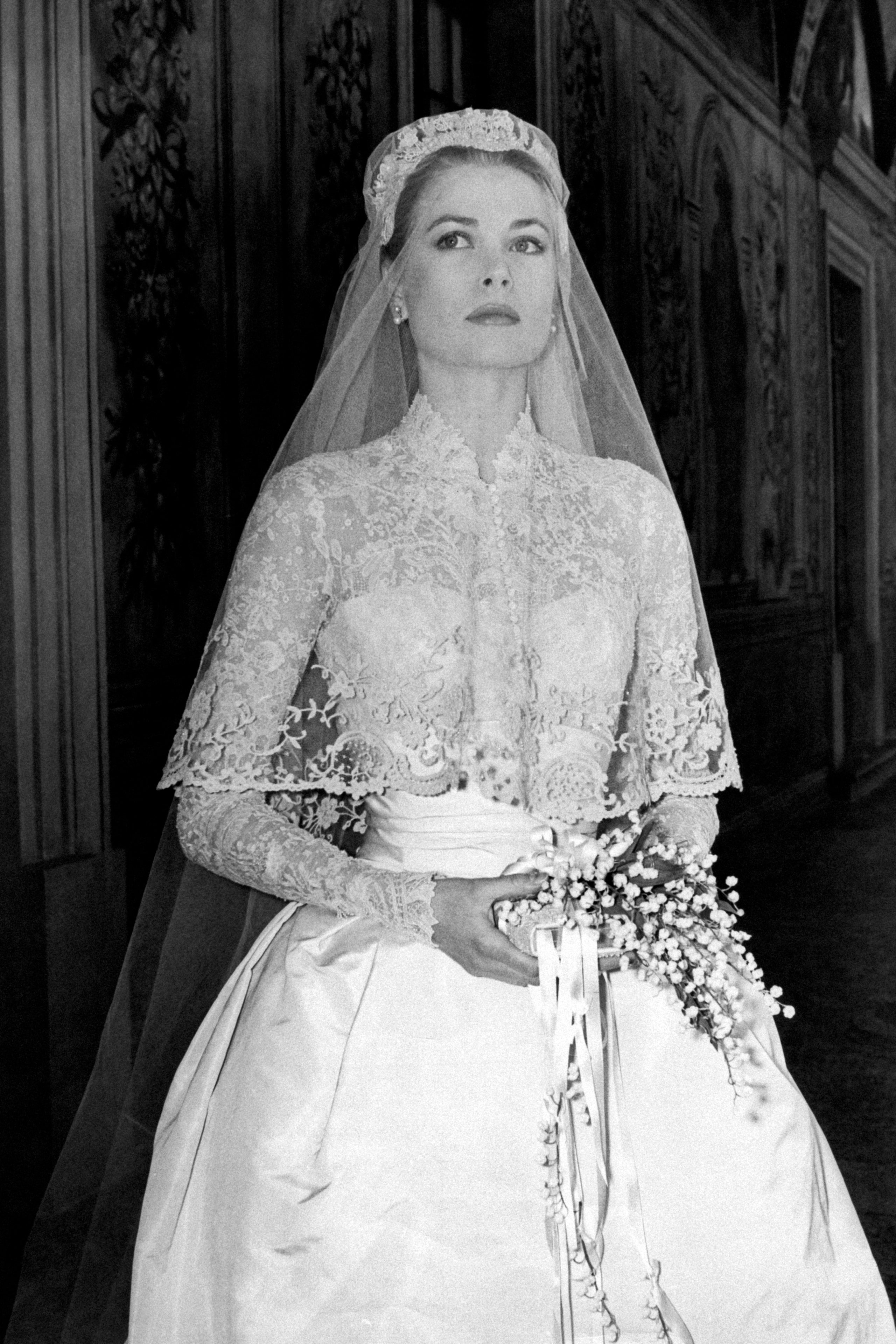 The big movie star Grace Kelly photographed in her bridal dress in a frescoed gallery within the Prince's Palace just...