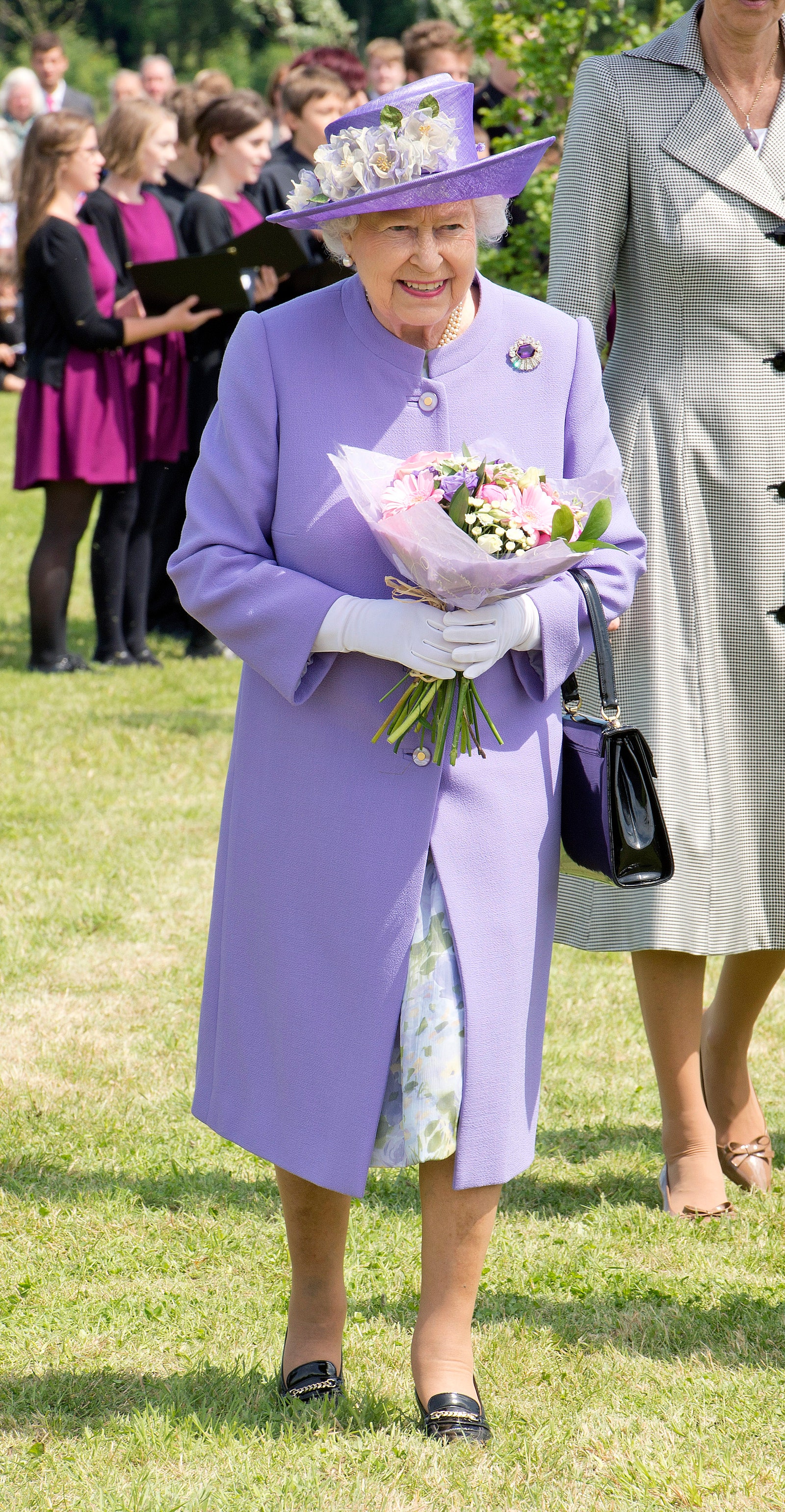 Image may contain Elizabeth II Human Person Hat Clothing Apparel Plant Flower Flower Bouquet and Flower Arrangement