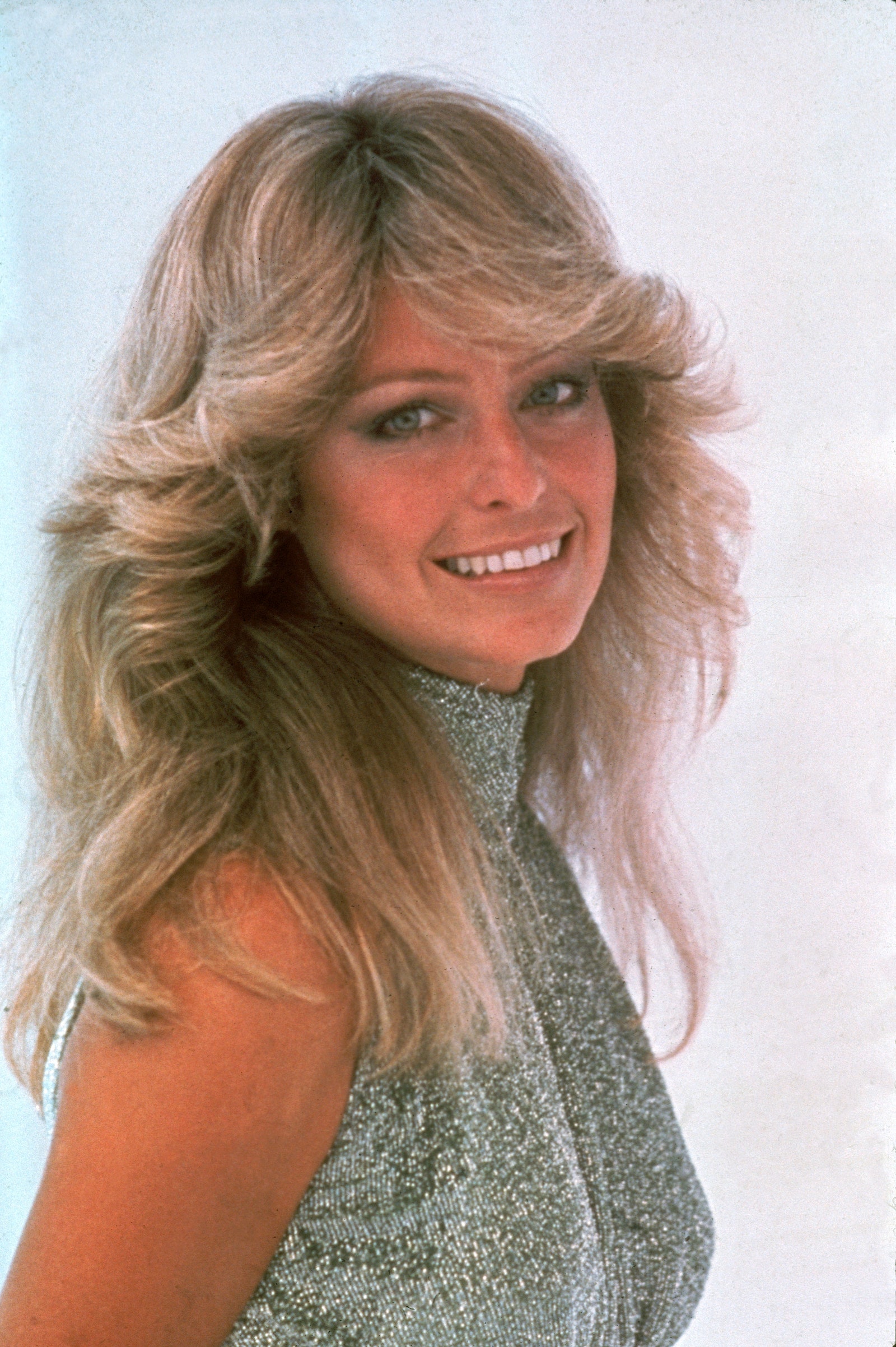 Image may contain Farrah Fawcett Face Human Person Blonde Teen Kid Child Hair Clothing Apparel and Smile