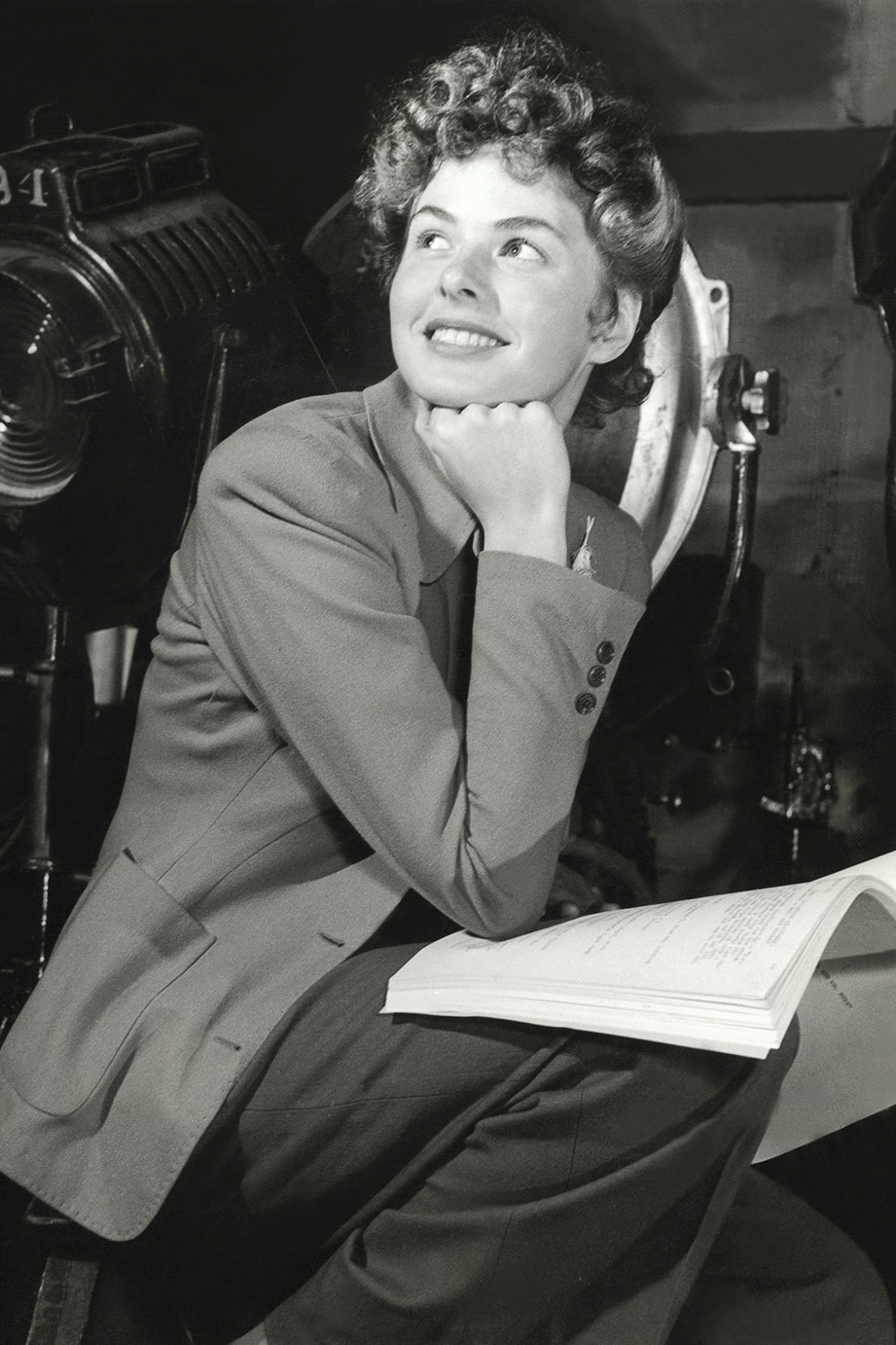 Swedish actress Ingrid Bergman sitting with a script on her lap resting her elbow on her leg and her chin on her fist on...