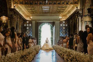 Image may contain Clothing Apparel Human Person Fashion Gown Indoors Robe Wedding and Aisle