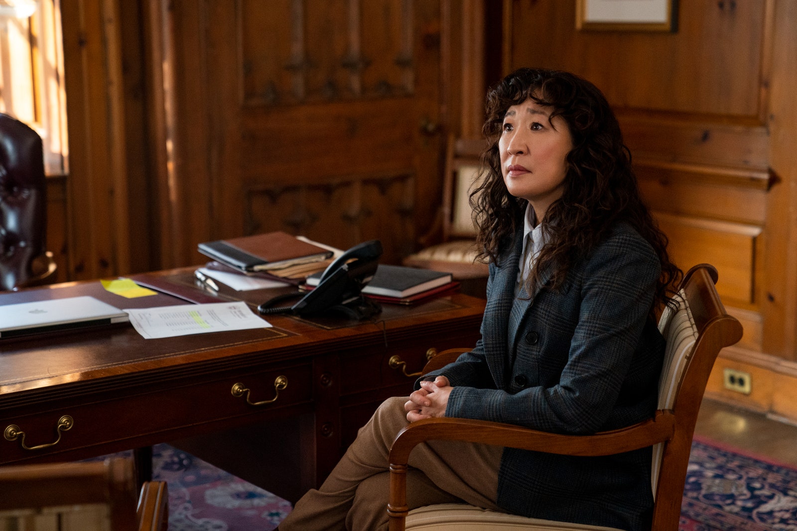Image may contain Furniture Desk Table Chair Human Person Sandra Oh Wood Couch Sitting Electronics and Computer