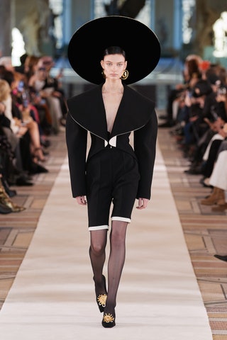 Image may contain Human Person Clothing Apparel Hat Fashion Runway and Sleeve