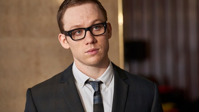 Image may contain Accessories Tie Accessory Joe Cole Human Person Clothing Suit Overcoat Apparel Coat and Glasses