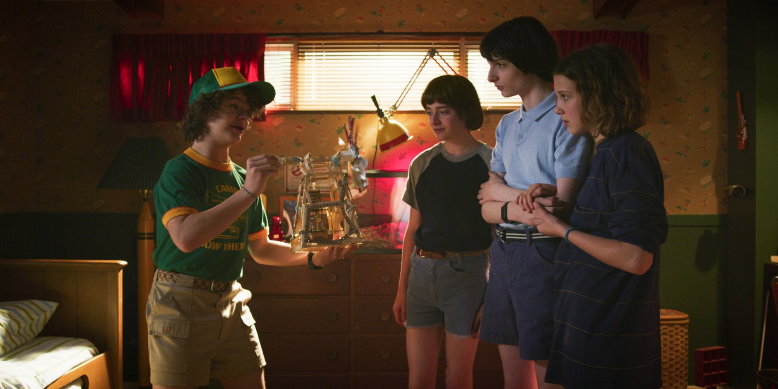 Image may contain Human Person Hat Clothing Apparel Gaten Matarazzo Shorts Finn Wolfhard Furniture and Couch