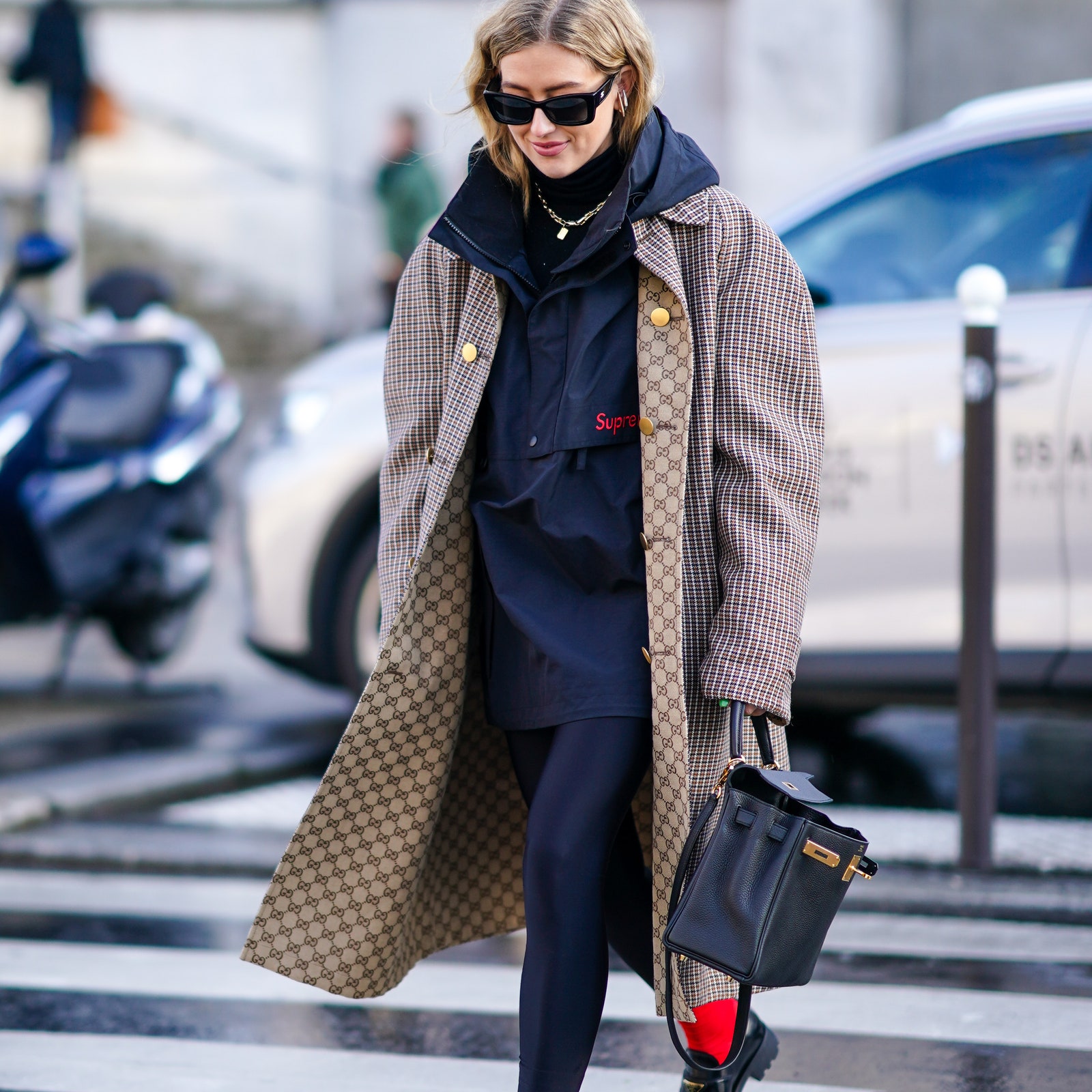 PARIS FRANCE  FEBRUARY 29 Emili Sindlev wears sunglasses a Supreme jacket with a hood a Gucci long oversized coat with...